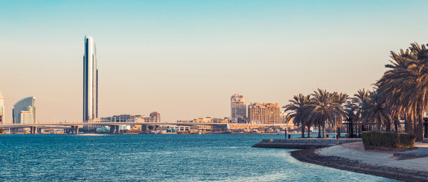 Dubai Creek bay with skyscrapers and palm trees in UAE