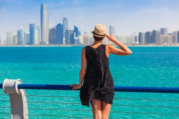 Foto op Canvas Tourist woman in Abu Dhabi, UAE. Sea, beach and skyscrapers background © oleg_p_100