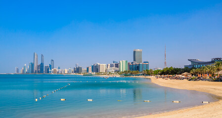 View of Abu Dhabi with sea, beach and skyscrapers. Travel in UAE