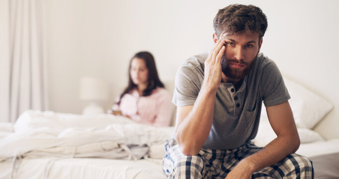 Angry couple, divorce and fight on bed in disagreement, conflict or toxic relationship at home. Upset and frustrated man and woman fighting, breakup or argument from affair or infertility in bedroom