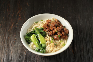 Mie Ayam, Indonesian Popular Street Food with Noodle, Chicken, and Green Vegetables