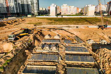 Arm of concrete pump ready for concrete conveying at construction site. Jib of concrete pump truck against sky at background. Truck Mounted Concrete Pump. View from above.