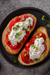 bruschetta with tomatoes and strachatella cheese