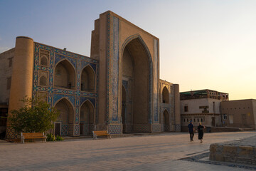 Fototapeta na wymiar Early sunny morning at the ancient Mirzo Ulugbek madrasah, Bukhara