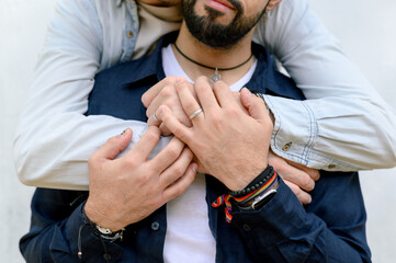 Crop boyfriends embracing on street