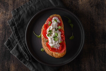bruschetta with tomatoes on a black plate