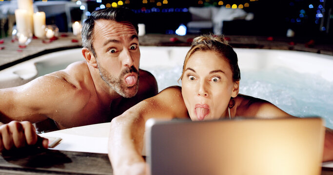 Tablet, Spa And Crazy Couple Take Selfie With Tongue For Social Media Or The Internet Or Online For A Romantic Night Date. Celebration, Web Or Funny Face By People On Vacation Or Holiday In A Hot Tub