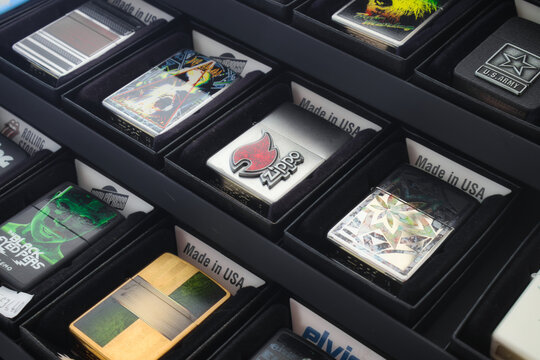 A collection of Zippo brand cigarette lighters in a retail display case