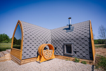 Firewood is placed in a round barrel near the igloo sauna