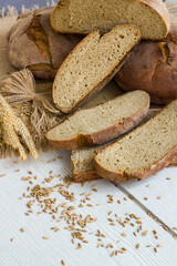 The ancestral bread of Seferihisar, Cittaslow city of Izmir, is made of Karakilcik Wheat sliced on wooden table wheat ears