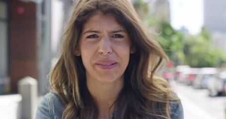 Face, stress and scream with a woman on a camcorder outdoor in the city for crazy emotional expression. Portrait, mental health or shout with a young female person on an urban road to show emotions