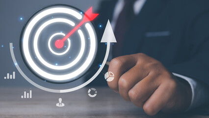 Businessman using magnifying glass with management target, success and planning.