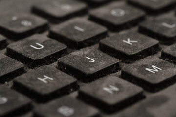 old black keyboard with keys covered in dust and dirt isolated on white background