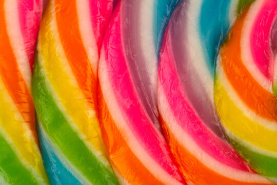 extreme closeup of colorful lollipop candy texture pattern on white background