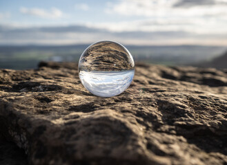 Crystal lens  ball on rocks