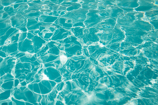 abstract blue swimming pool water background and sun light