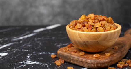 Raisins. Sun-dried grapes in wooden bowl. superfood. Vegetarian food concept. healthy snacks. Copy...