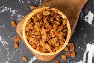 Raisins. Sun-dried grapes in wooden bowl. superfood. Vegetarian food concept. healthy snacks. close up
