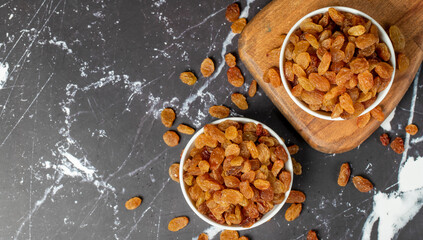 Raisins. Sun-dried grapes in ceramic bowl. superfood. Vegetarian food concept. healthy snacks. Top view. Copy space. Empty space for text