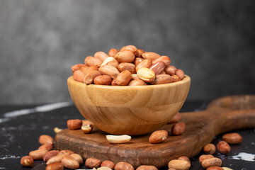 Peanut. Peanuts peeled in a wooden bowl. superfood. Vegetarian food concept. healthy snacks