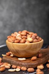 Fototapeta na wymiar Peanut. Peanuts peeled in a wooden bowl. superfood. Vegetarian food concept. healthy snacks. close up