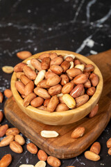 Peanut. Peanuts peeled in a wooden bowl. superfood. Vegetarian food concept. healthy snacks. close up