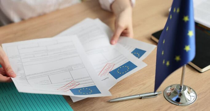 Woman holds application for Schengen visa with approved stamp closeup. Schengen visa to Europe for students