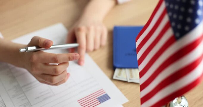 Persons fill out an application for American visa at embassy closeup. Study trip to America