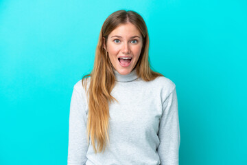 Young blonde woman isolated on blue background with surprise facial expression