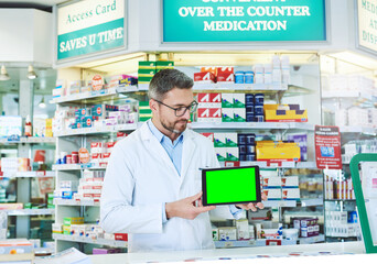 Man, pharmacist and tablet with green screen with health, store and mockup with pharmaceutical promo on app. Mature pharma expert, digital touchscreen and space with chromakey for mock up in shop