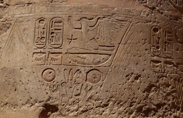 Ancient egyptian wall reliefs and pharaonic symbols carved at Karnak temple in Luxor, Egypt 