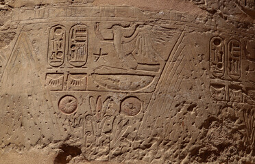 Ancient egyptian wall reliefs and pharaonic symbols carved at Karnak temple in Luxor, Egypt 