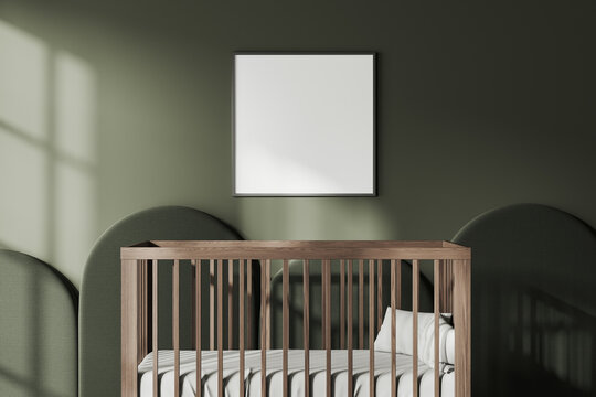 Green baby room interior with crib and mockup frame