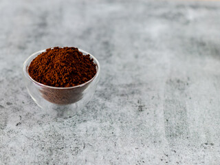High angle of coffee powder in glass bowl with Copy space on Defocused background.