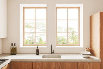 Beige kitchen interior with kitchenware, sink and panoramic window
