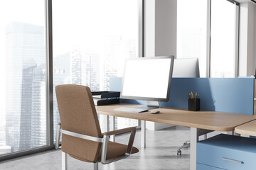Mock up computer screen on blue and wooden office table