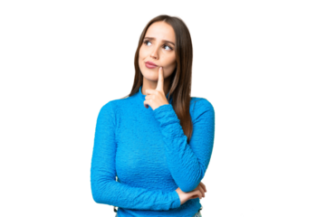 Young beautiful woman over isolated chroma key background having doubts while looking up