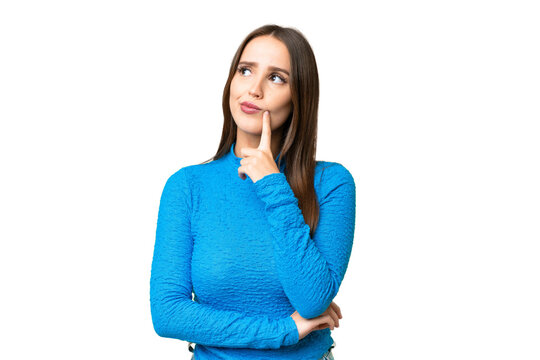 Young beautiful woman over isolated chroma key background having doubts while looking up