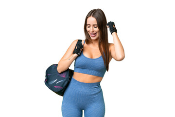 Young sport woman with sport bag over isolated chroma key background celebrating a victory