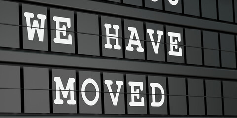 Fototapeta premium We have moved. Black timetable display with the text, we have open in white letters. Searching, relocation, new address, announcement, office, direction, service, and business.