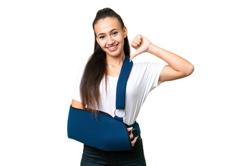 Young Arabian woman with broken arm and wearing a sling over isolated chroma key background proud...