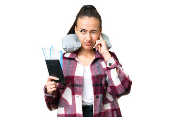 Young Traveler woman holding a passport over isolated chroma key background frustrated and covering ears