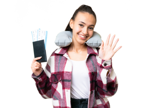Young Traveler woman holding a passport over isolated chroma key background saluting with hand with happy expression