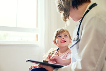 Young girl, doctor and consultation with medical checklist with a smile in a hospital for wellness. Happiness, clinic consultant and pediatrician with healthcare and kids appointment with child form