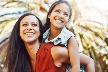 Happy, outdoor and mother giving her child piggyback ride in the garden of the backyard of their...