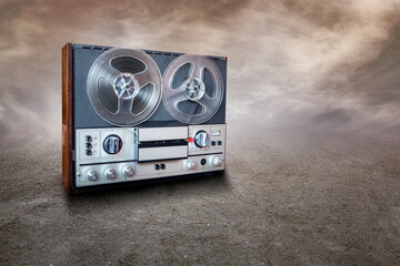 Fototapeta premium retro audio recorder on standing on a sandy surface