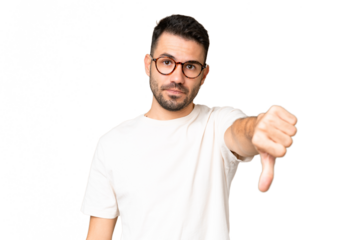 Young handsome caucasian man over isolated chroma key background showing thumb down with negative expression