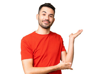 Young handsome caucasian man over isolated chroma key background extending hands to the side for...