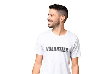 Fototapeta premium Young volunteer caucasian man over isolated chroma key background looking side