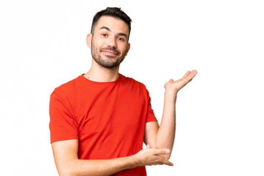 Young handsome caucasian man over isolated chroma key background extending hands to the side for inviting to come